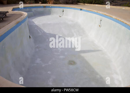 Swimming Pool emptied  to be serviced with lights hanging down . Stock Image. Stock Photo