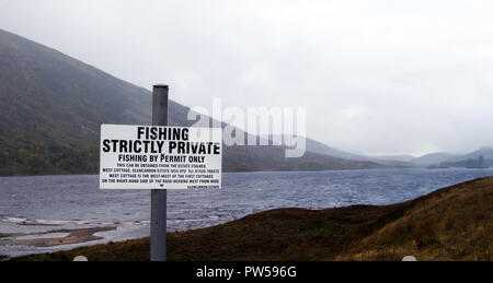 A - 'Fishing Strictly Private' sign greets you on the road that runs up the side of Loch Carron in Scotland. The sign tells you where you can buy a permit so you can fish in peace and quite. Apart from the midges! Stock Photo