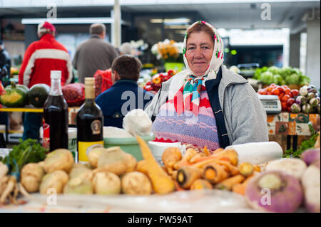 MARIBOR, SLOVENIA - OCT 16: a woman sells local vegetables at the local market in Maribor, Slovenia on October 16, 2011. Stock Photo