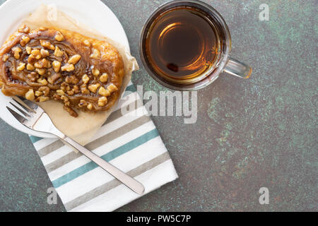 dessert of sticky bun and coffee on green background Stock Photo