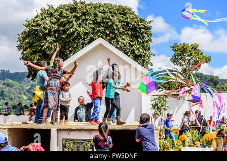 Santiago Sacatepequez, Guatemala - November 1, 2017: Flying kites honoring spirits of the dead in cemetery on All Saints Day. Stock Photo