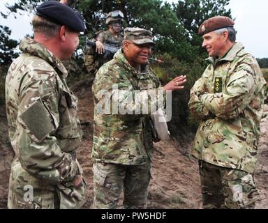 Col. Shawn Harris, commander of Michigan Army National Guard 63rd Troop Command greets leadership members of the Scottish and North Irish Yeomanry as their combined units take part in the final training event of Exercise Viking Star 2017 September 20, 2017, at Danish Home Guard Nymindegab Training Center in Denmark. Exercise Viking Star 2017 is an Overseas Deployment for Training (ODT) involving the 1-125th Infantry Regiment of the Michigan Army National Guard. Soldiers from Bravo Company based in Saginaw, Michigan, conduct combative training, orienteering and joint live fire exercises with th Stock Photo