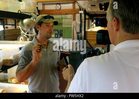 James Lee, a biologist with The Nature Conservancy, is interviewed by the media in the gopher tortoise nursery before going to the release site. The goal of the Head-Start Program at Camp Shelby is to supplement the current, aging population of tortoises with offspring raised to a size that will greatly increase their chances of survival in the wild. Training at Camp Shelby has very little negative effect on the tortoises, Lee said, and the frequent controlled burns actually improve their habitat. Gopher tortoises can live more than 70 years and the primary threat is predation of tortoises und Stock Photo