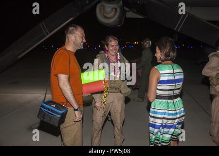 Capt. Ashley Myers, an aircraft commander with Marine Medium Tiltrotor Squadron (VMM) 268, nicknamed the “Red Dragons,” is greeted by loved ones after completing a trans-Pacific flight from Australia, Marine Corps Base Hawaii (MCBH), Sept. 19, 2017. The “Red Dragons” supported the Australian Defence Force as the aviation combat element for the Marine Air-Ground Task Force (MAGTF) with Marine Rotational Force Darwin (MRF-D), Australia. These are the first Trans-Pacific flights the MV-22 Ospreys have conducted from Hawaii to Australia. This movement demonstrates that the unfueled range of our MV Stock Photo