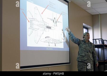 Staff Sgt. Beth Rodas, a geospatial intelligence analyst with the Intelligence, Surveillance and Reconnaissance Group (ISRG) at the 132nd Wing, Iowa Air National Guard in Des Moines, Iowa, gives a presentation to high school students about identifying aircraft, submarines and other military vehicles in satellite imagery during the Iowa National Guard’s inaugural STEM (Science, Technology, Engineering and Math) Day event at Camp Dodge, in Johnston, Iowa, on Sept. 20. Rodas is a member of the ISRG’s STEM Outreach Program and works regularly with the Governor’s STEM council to spread the word abo Stock Photo