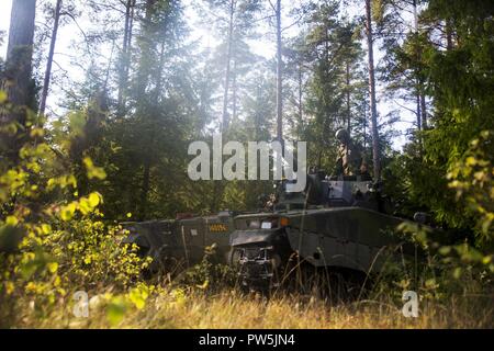 Swedish soldier changes turret position of the Swedish Strf-90 tracked infantry fighting vehicle during Exercise Aurora 17 in Lärbro, Sweden, Sept. 21, 2017. Aurora 17 is the largest Swedish national exercise in more than 20 years, and it includes supporting forces from the U.S. and other nations in order to exercise Sweden’s defense capability and promote common regional security. Stock Photo
