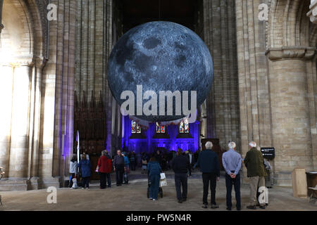 Peterborough, UK. 12th Oct 2018. Peterborough has got a touring artwork of the Moon within the 12th Century Peterborough Cathedral. Museum of the Moon has been created by UK artist Luke Jerram, and The Moon, measuring 7 metres in diameter, and has been seen by thousands of visitors since its arrival earlier this month.  **This picture is for editorial use only** Credit: Paul Marriott/Alamy Live News Stock Photo