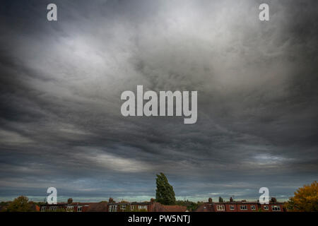 Wimbledon, London, UK. 12 October, 2018. Clouds seen above London formed into unusual swirling masses as they streamed in from the south, carried through by strong winds from Storm Callum. Credit: Malcolm Park/Alamy Live News. Stock Photo