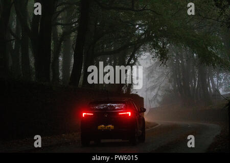 Flintshire, North Wales, 13th October 2018. UK Weather: Heavy rain for most today with weather warnings in place and flood warnings for parts of Wales. A car travelling down a wet and misty lane in the village of Halkyn, Flintshire during heavy rain  © DGDImages/AlamyNews Stock Photo