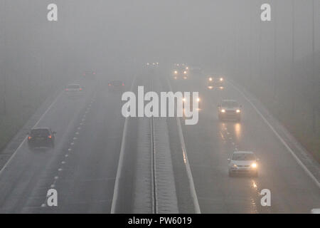 Flintshire, North Wales, 13th October 2018. UK Weather: Heavy rain for most today with weather warnings in place and flood warnings for parts of Wales. Dangerous road conditions along the A55 in North Wales with heavy rain and mist near to the village of Halkyn, Flinthsire © DGDImages/AlamyNews Stock Photo