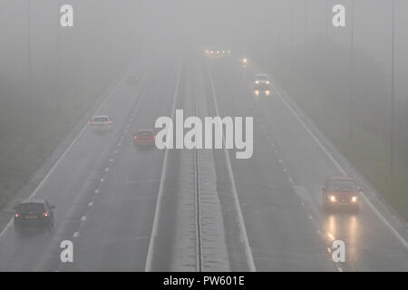 Flintshire, North Wales, 13th October 2018. UK Weather: Heavy rain for most today with weather warnings in place and flood warnings for parts of Wales. Dangerous road conditions along the A55 in North Wales with heavy rain and mist near to the village of Halkyn, Flinthsire © DGDImages/AlamyNews Stock Photo