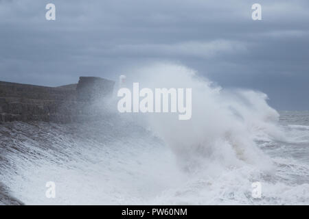 Porthcawl, South Wales, UK.  13 October 2018.  UK weather: Large waves hit the coast this morning, as the country continues to be battered  by Storm Callum. Credit: Andrew Bartlett/Alamy Live News. Stock Photo
