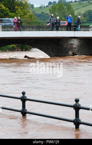 Brecon, Powys, Wales - Saturday 13th October 2018 - Visitors stop to look at the very high river levels on the River Usk as it flows through Brecon town following torrential rain in the South Wales area during Storm Callum.  Photo Steven May / Alamy Live News Stock Photo