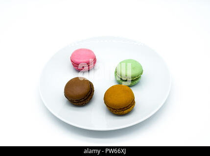 macarons on plate, sweet colorful macarons on white background Stock Photo