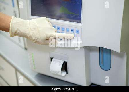 the specialist of the laboratory displays the data on the composition of blood components after processing in a special apparatus on the screen, close-up Stock Photo