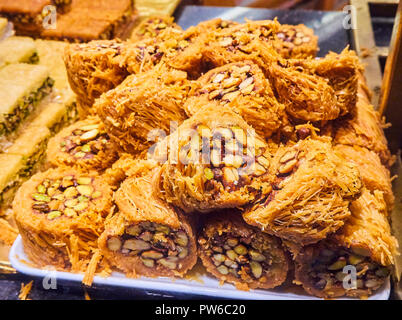 Baklava, a traditional Arab dessert made with layers of Filo, a very thin unleavened dough and filling of nuts. Stock Photo