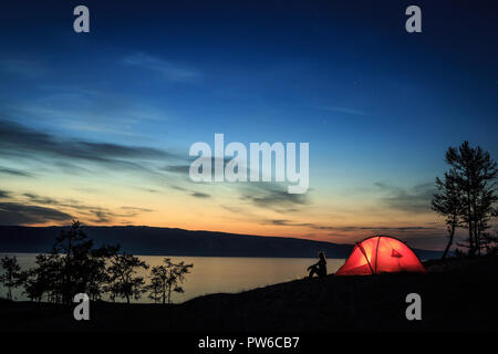 Silhouette of a girl near a tent Stock Photo