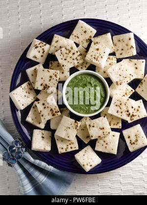 WHITE DHOKLA WITH BLACK PEPPER AND CORIANDER CHUTNEY Stock Photo