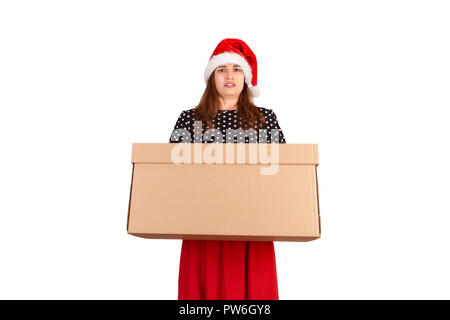 Portrait of excited surprised girl in dress holding big and heavy gift box. isolated on white background. holidays concept. Stock Photo