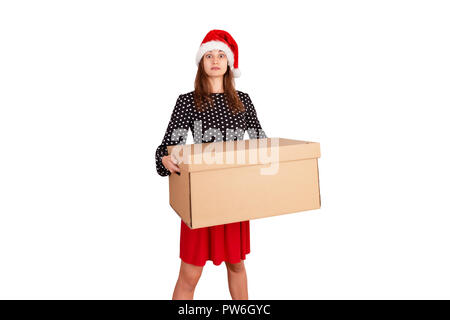 Portrait of excited surprised girl in dress holding big and heavy gift box. isolated on white background. holidays concept. Stock Photo