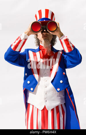 Uncle Sam looking through large binoculars. Stock Photo