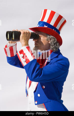 looking Sam Alamy - through large Uncle binoculars Photo Stock