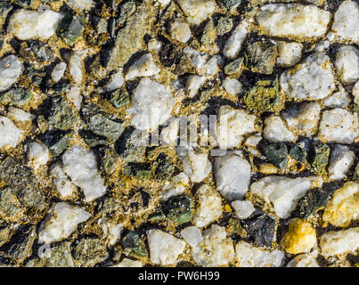 Macro close up texture of a pavement made of all kinds of tiny rocks beautiful background texture Stock Photo
