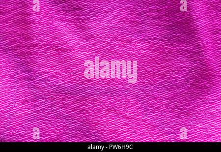 Deep vibrant pink colored cotton cloth fabric macro close up background Stock Photo