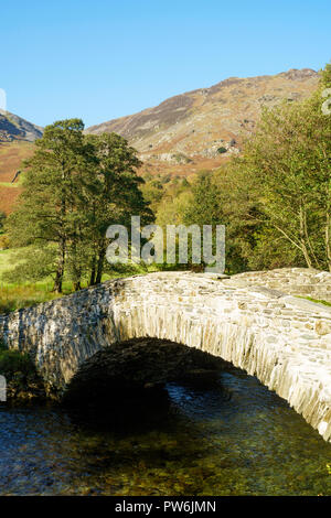 Old stone packhorse bridge over the river Derwent near Rosthwaite, Cumbria, England, UK Stock Photo