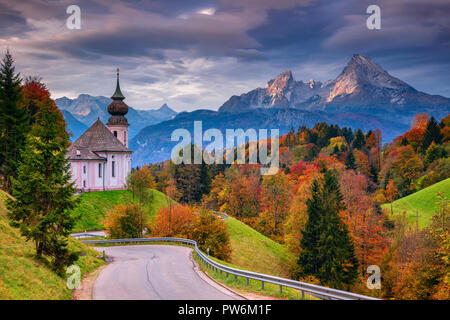 Autumn in Alps. Image of the Bavarian Alps with Maria Gern Church and Watzmann mountain during beautiful autumn sunrise. Stock Photo