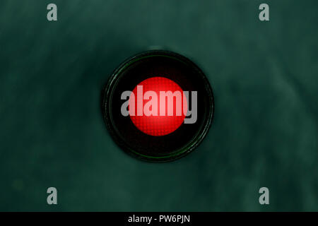 An overhead photo of a vibrant red button, a kill switch on a dark panel with copy space Stock Photo