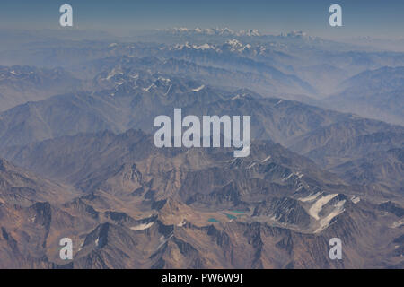 Aerial view of the mountains of Afghanistan with the Pamir Range in Tajikistan in the background Stock Photo