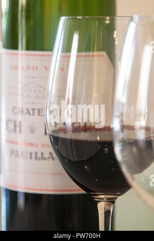 Pauillac Bordeaux red wine in a glass, in front of a bottle Stock Photo