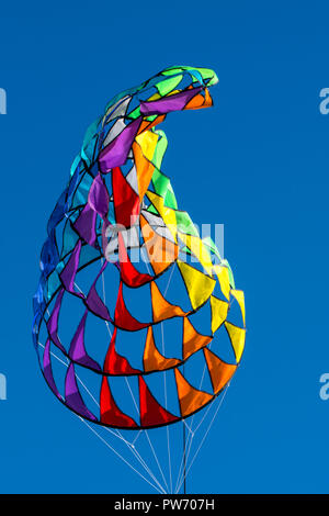 bright, rainbow colors, geometric patterns of kites on the background of pure blue sky Stock Photo