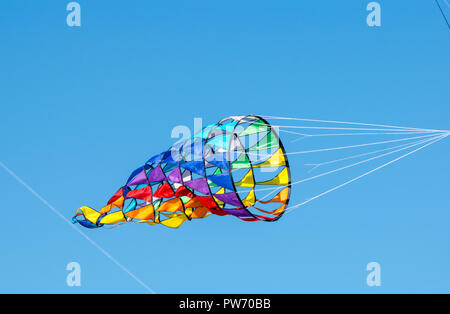 bright, rainbow colors, geometric patterns of kites on the background of pure blue sky Stock Photo