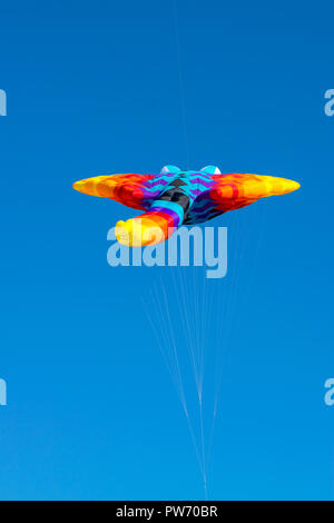 bright, rainbow colors, geometric patterns of kites on the background of pure blue sky Stock Photo