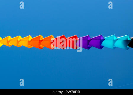 bright, rainbow colors, geometric patterns of kites on the background of pure blue sky Stock Photo