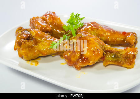 Korean sauce fried chickens in the dish on  isolated white background Stock Photo