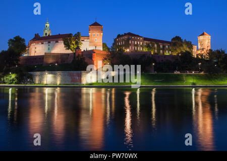 Wawel Royal Castle at night in Krakow, Poland, view across the Vistula River, city landmark. Stock Photo