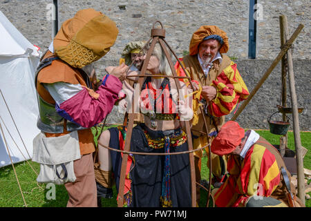 Bellinzona, Switzerland - 27 May 2018: girl in a cage at the medieval historical re-enactment on Castelgrande castle at Bellinzona on the Swiss alps Stock Photo