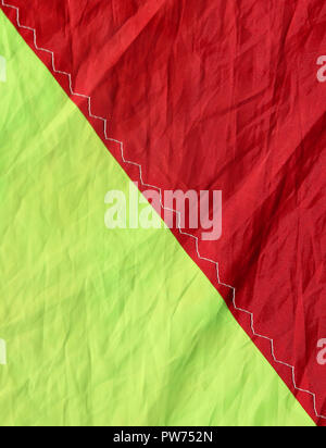 Nylon fabric in two bright red and yellow colors divided in half with a seam Stock Photo
