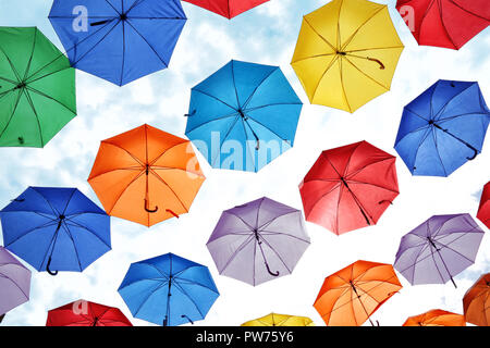 colorful umbrellas hanging against the sky. Stock Photo