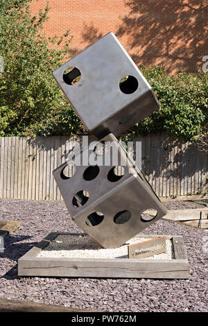 "Take a Chance" two tumbling dice sculpture in stainless steel by Arthur Francis Sculpture on display in Market Harborough, Leicestershire, England,UK Stock Photo