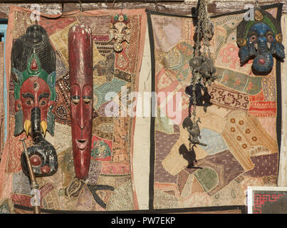 Masks and tapestries at a craft shop in Leh, Ladakh, India Stock Photo