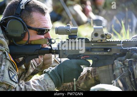 U.S. Army Col. William Lindner, Chief of Staff of the 7th Army Training Command (7th ATC), fires a Czech rifle during the European Best Sniper Squad Competition at the 7th ATC’s Grafenwoehr training area, Germany, Sept. 24, 2017. The European Best Sniper Squad Competition is an U.S. Army Europe competition challenging militaries from across Europe to compete and enhance teamwork with Allies and partner nations. The competition is multinational by design and involves units from 14 countries. Stock Photo