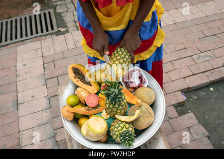 Unidentifiable street fruit vendor in action. Cartagena de Indias, Colombia. Sep 2018 Stock Photo