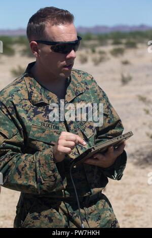 U.S Marine Corps Maj. Eben Buxton, CH-53E instructor with Marine Aviation Weapons and Tactics Squadron One (MAWTS-1) prepares a tablet to provide digitally aided close air support in support of Weapons Tactics Instructors course (WTI) 1-18 at Fire Base Burt, Calif., Sept. 22, 2017. WTI is a seven-week training even hosted by MAWTS-1 cadre, which emphasizes operational integration of the six functions of Marine Corps aviation in support of a Marine Air Ground Task Force and provides standardized advance tactical training and certification of unit instructor qualifications to support Marine avia Stock Photo