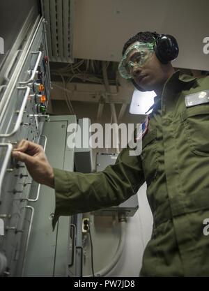 5TH FLEET AREA OF OPERATIONS (Sept. 22, 2017) Marine Corps Cpl. Luis Rosario, a native of Bronx, New York, assigned to the 15th Marine Expeditionary Unit aboard the amphibious assault ship USS America (LHA 6), tests a hydraulic line using a T-10 hydraulic component test stand in the ship’s aviation hydraulic pneumatic shop. America is the flagship for the America Amphibious Ready Group and, with the embarked 15th MEU, is deployed to the U.S. 5th Fleet area of operations in support of maritime security operations to reassure allies and partners and preserve the freedom of navigation and the fre Stock Photo