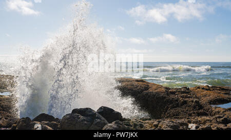 Water erupting out of Thor's Well, landmark hole in the ground located on the Oregon coast. Stock Photo