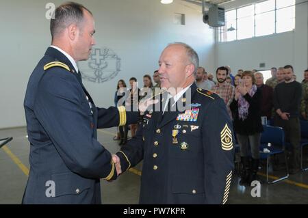 Oregon Army National Guard Brig. Gen. William Edwards, Land Component Commander, shakes hands with Command. Sgt. Maj. Brunk W. Conley after awarding him the Oregon National Guard Commendation Medal during a retirement ceremony on September 22, 2017, at the Corvallis Armory. Conley said that the medal meant a lot because it showed his dedication to his home state. Stock Photo